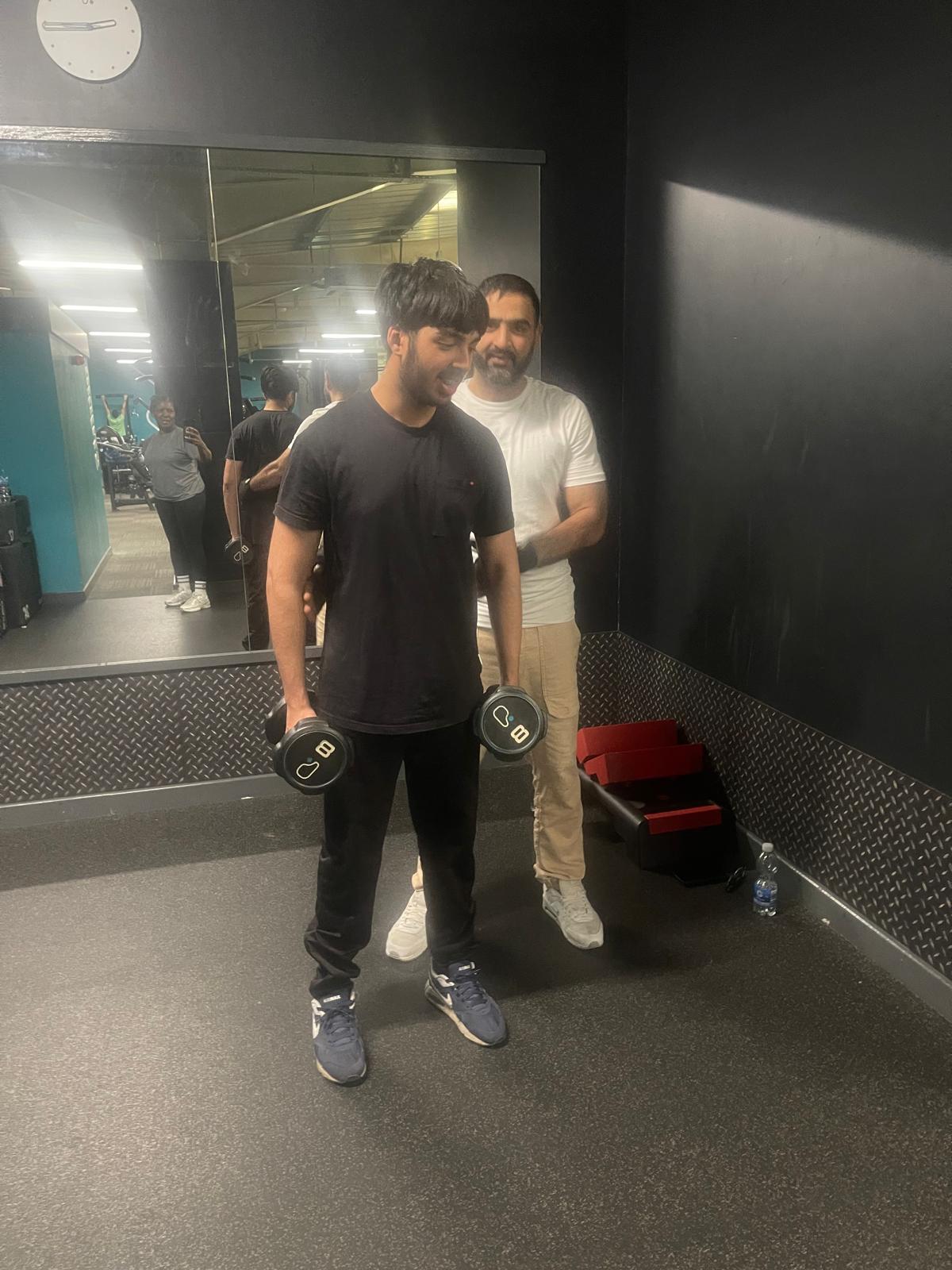Coached dumbbell shoulder press with trainer