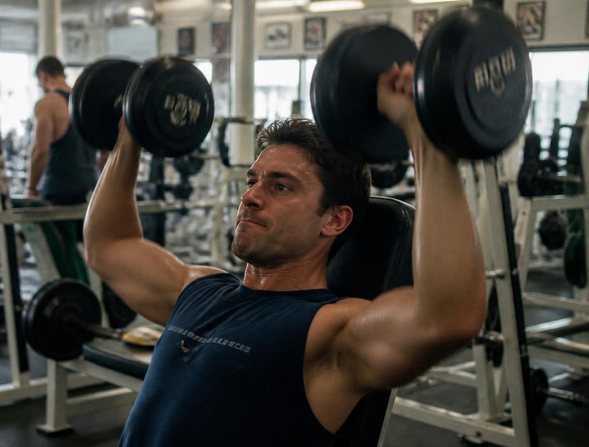 Seated dumbbell shoulder press during a training session